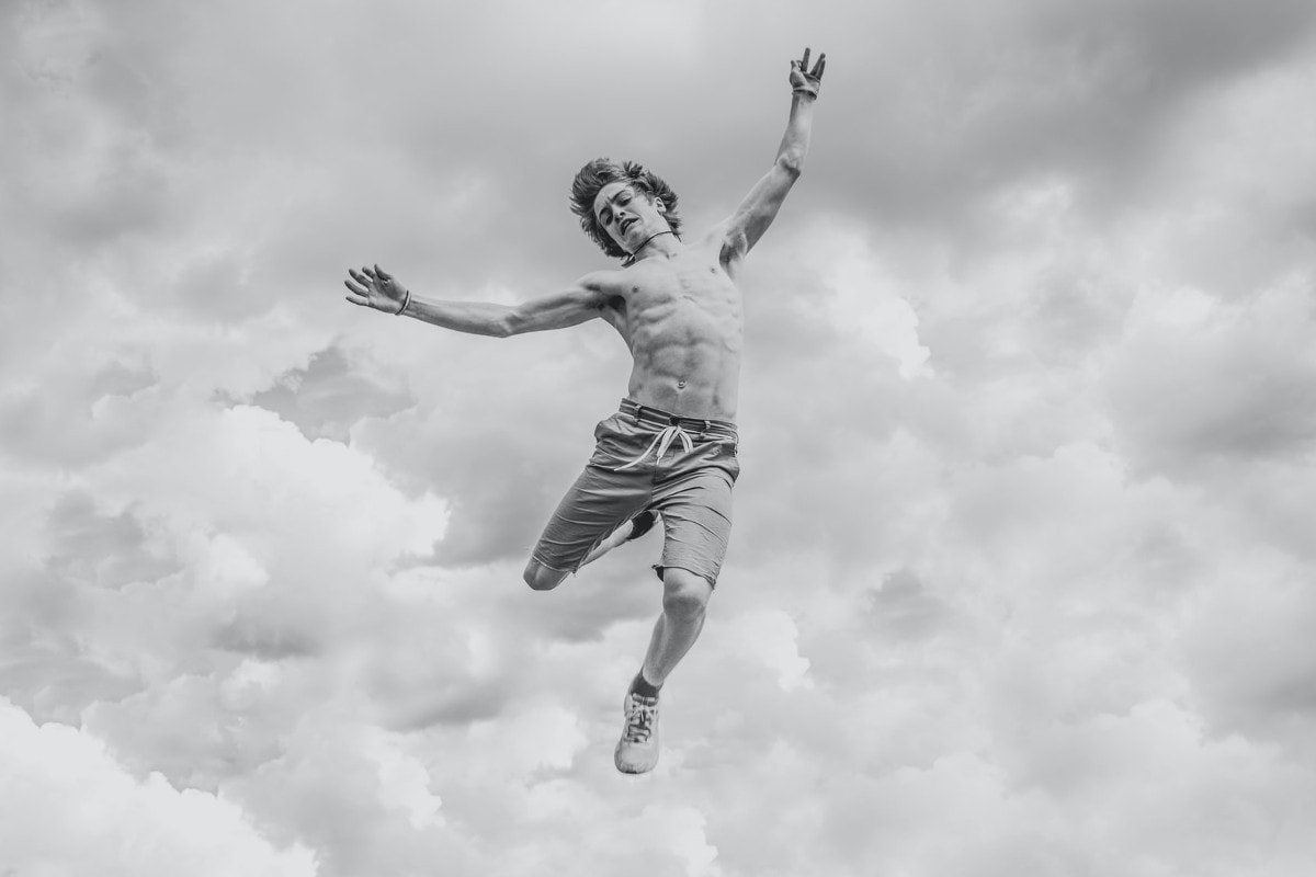 Scared Young Man Falling Through Sky in Black and White